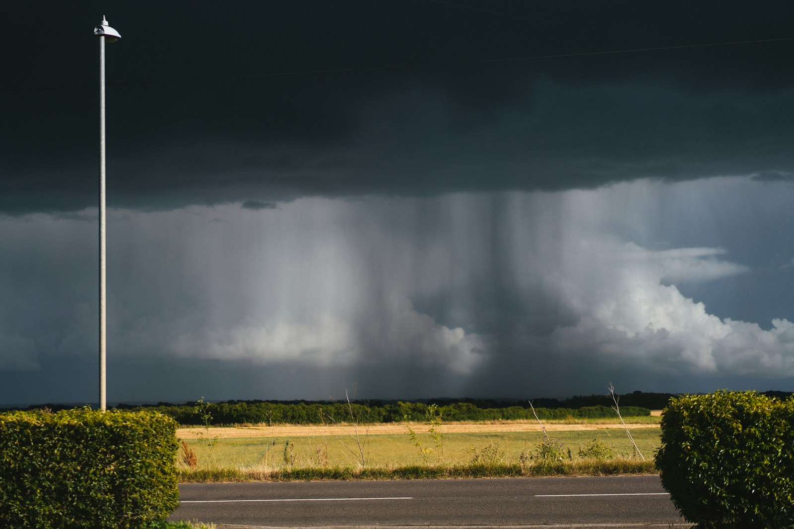 A storm moving across the sky over a road